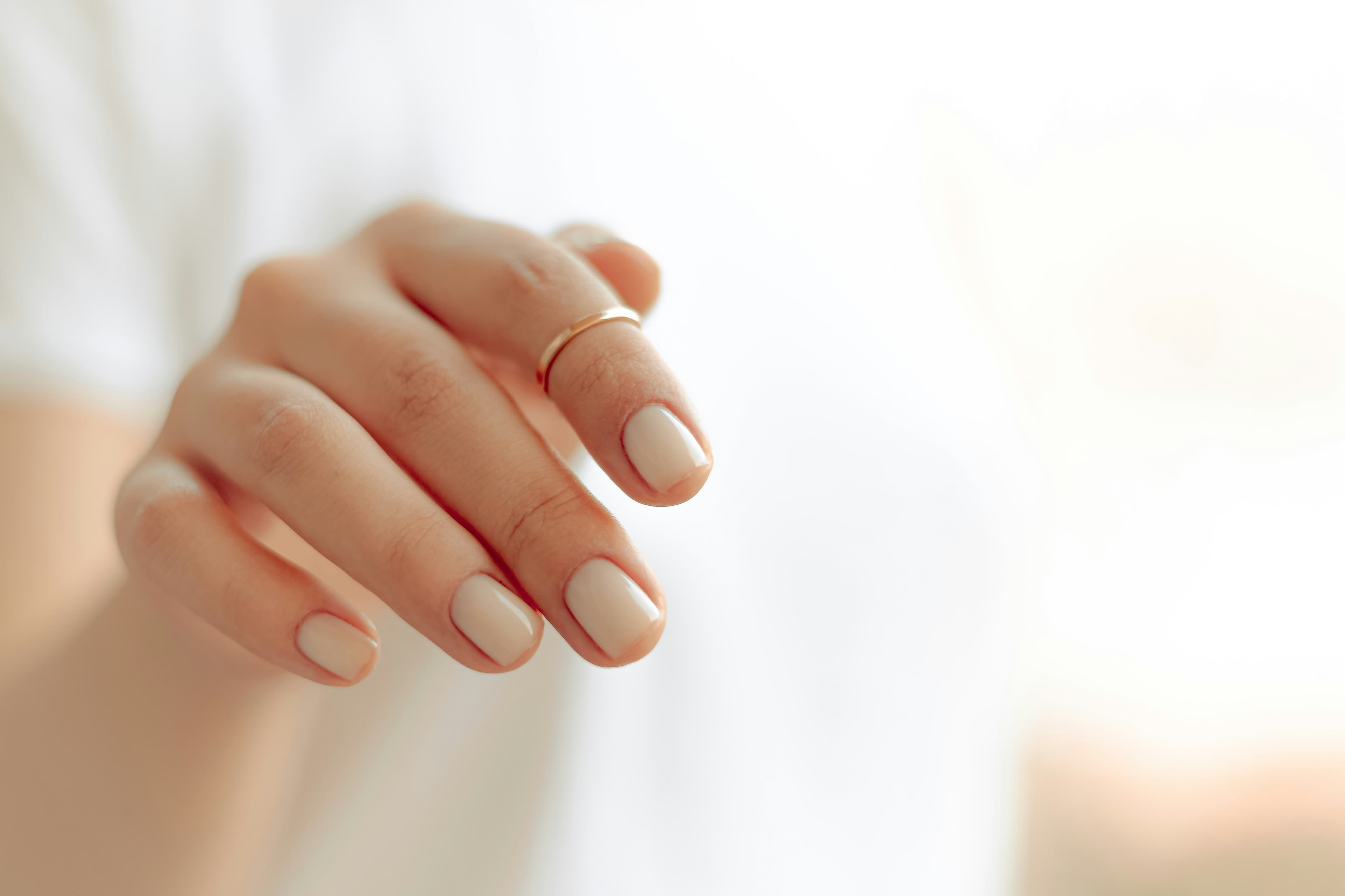 Macro close-up of a glossy, clean manicure on one hand